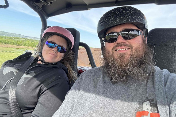 Two people wearing AXEL Off Road GRIT Helmets in Pink and White for DOT off-roading