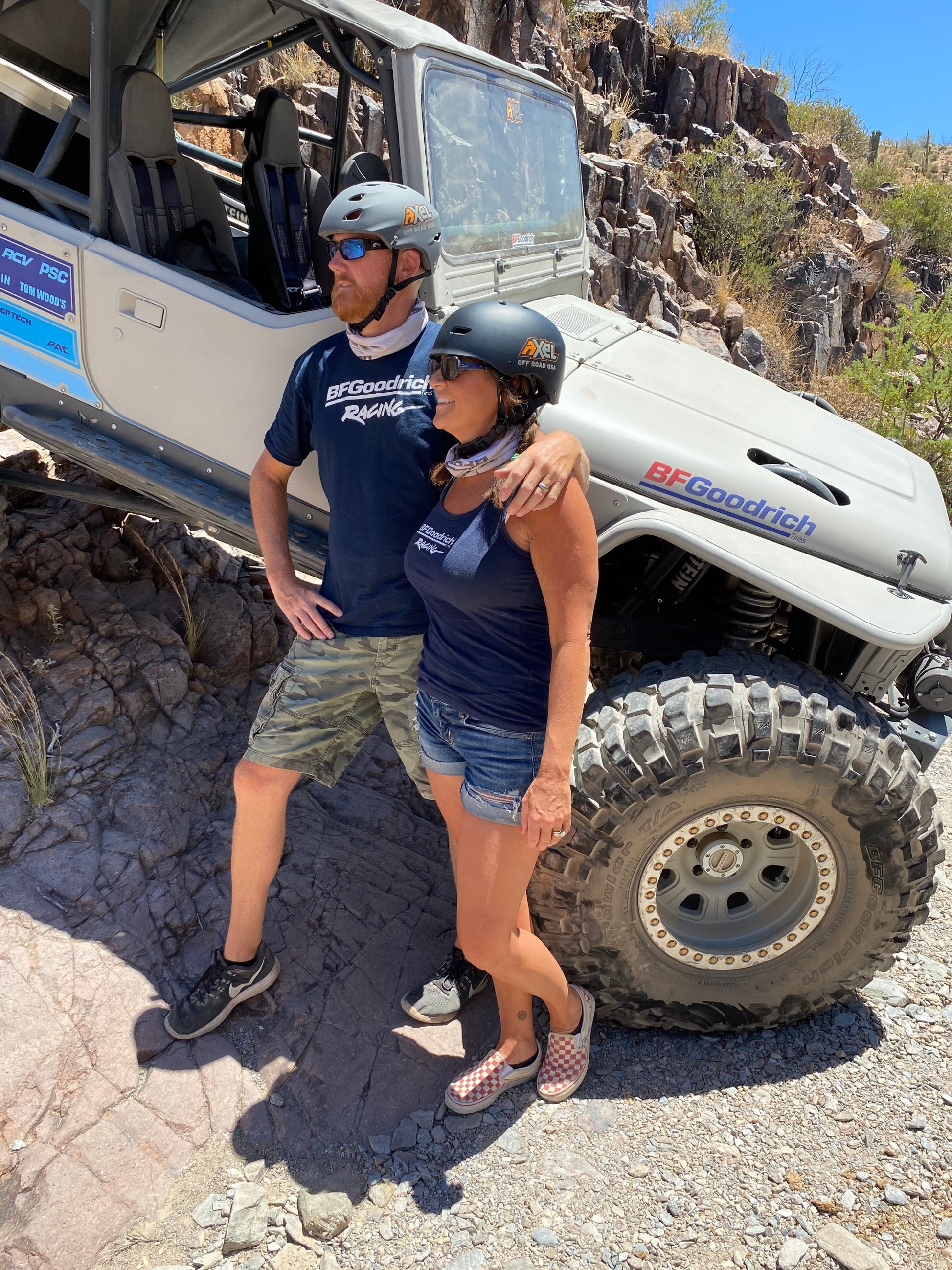 Two people wearing Axel Off Road Helmets in front of a Jeep